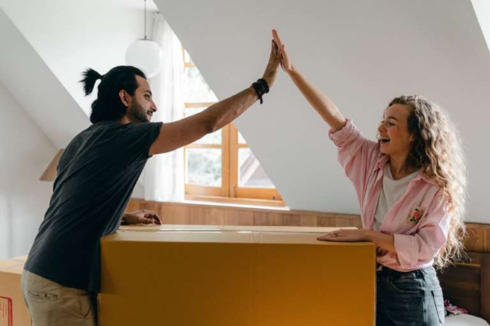 a girl and a man giving each other a high five