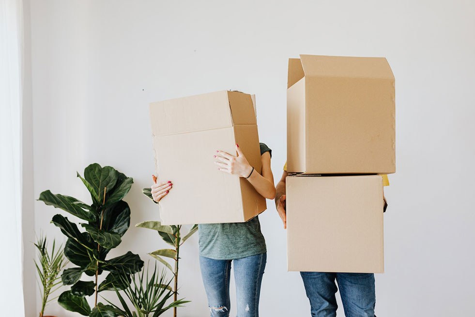 a couple of people holding boxes