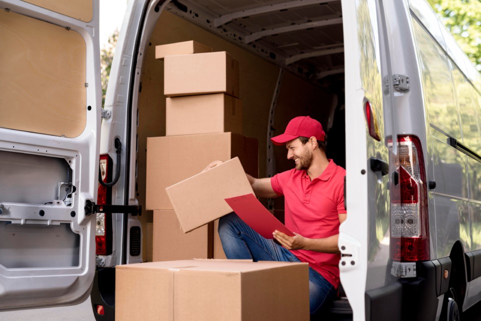 a man sitting in the back of a van with boxes