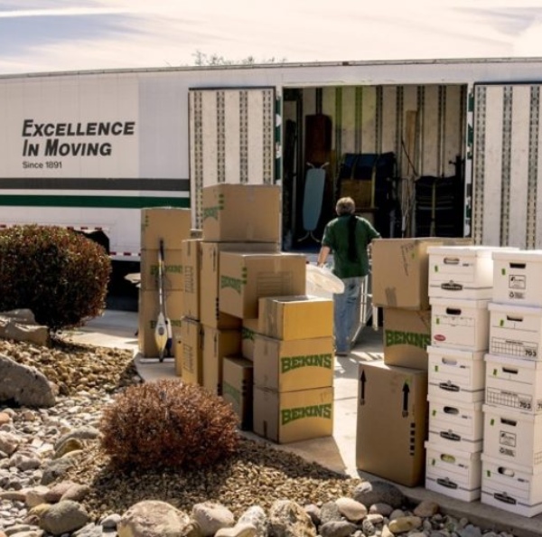 A lot of Bekins cardboard boxes on the side of a truck