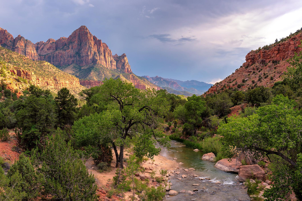 a river running through a canyon in the background