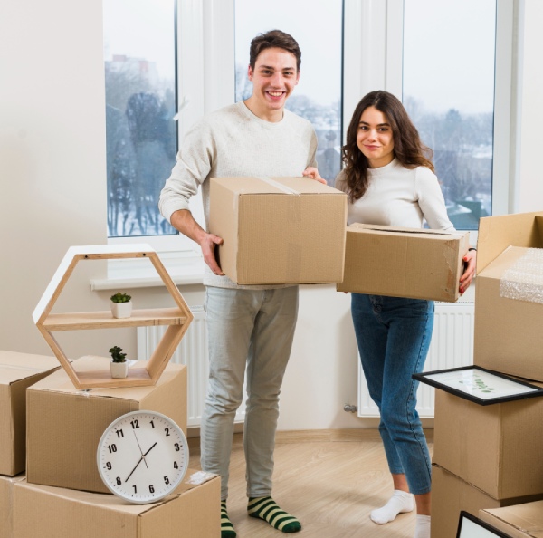 a boy and a girl holding cardboard boxes