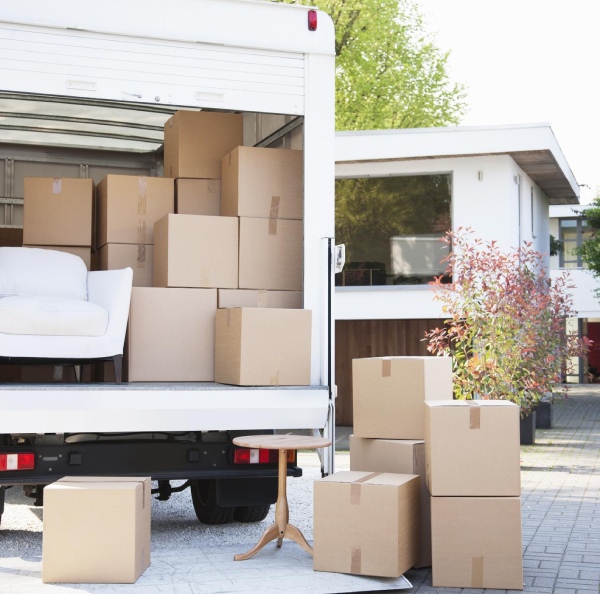 cardboard boxes and a white sofa in a truck