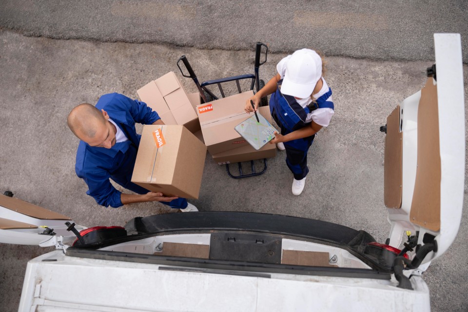 a man and woman standing next to boxes