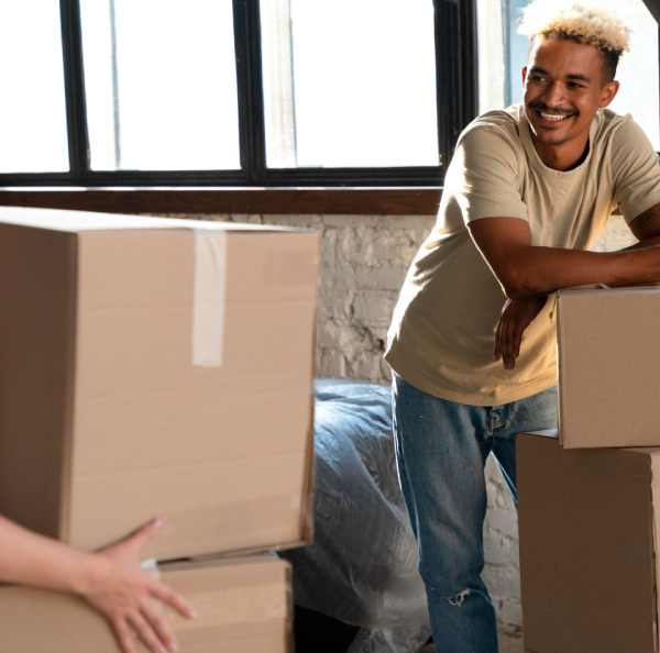 a man leaning on a stack of boxes