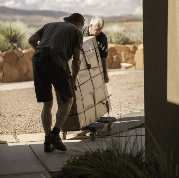 two men taking out packed boxes