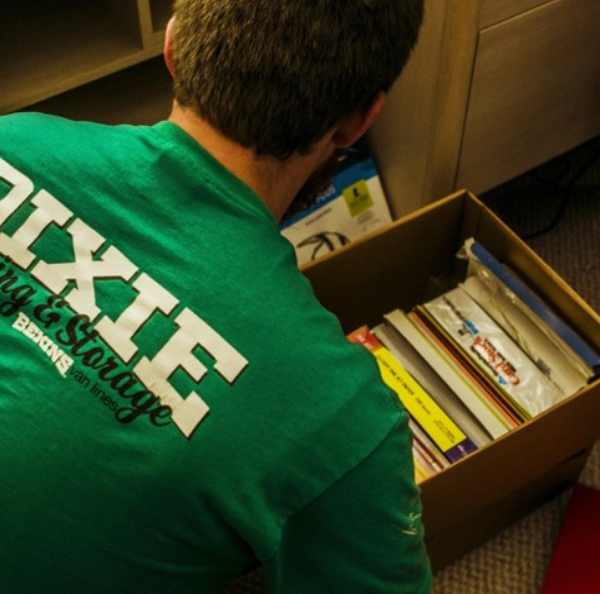 a person looking at a box of books