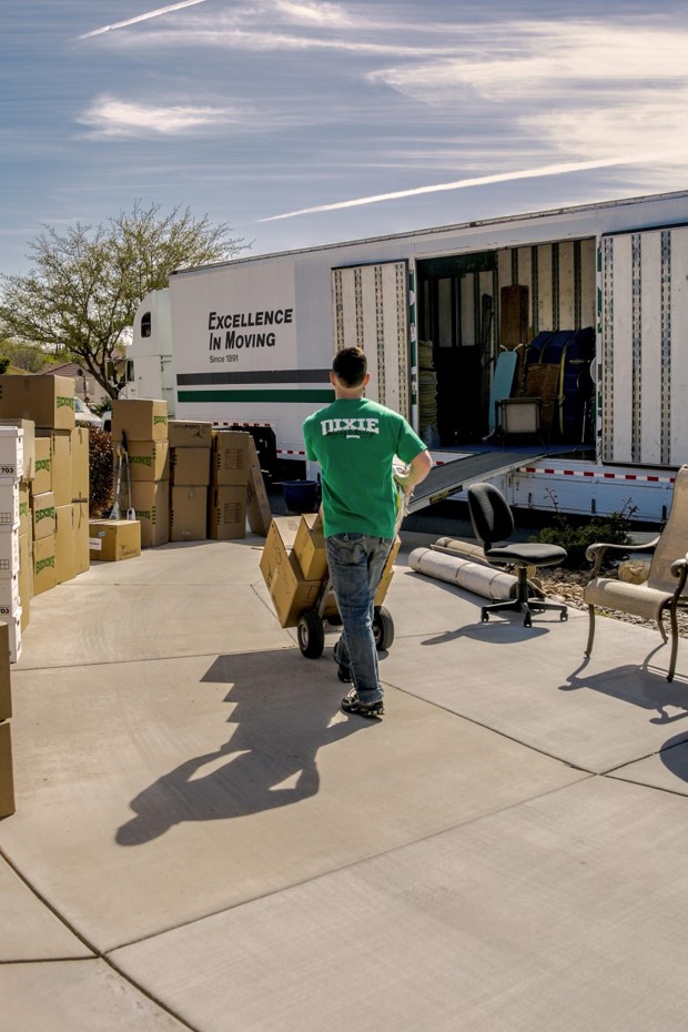 a man carrying boxes in a truck