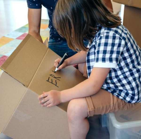 a child writing on a box